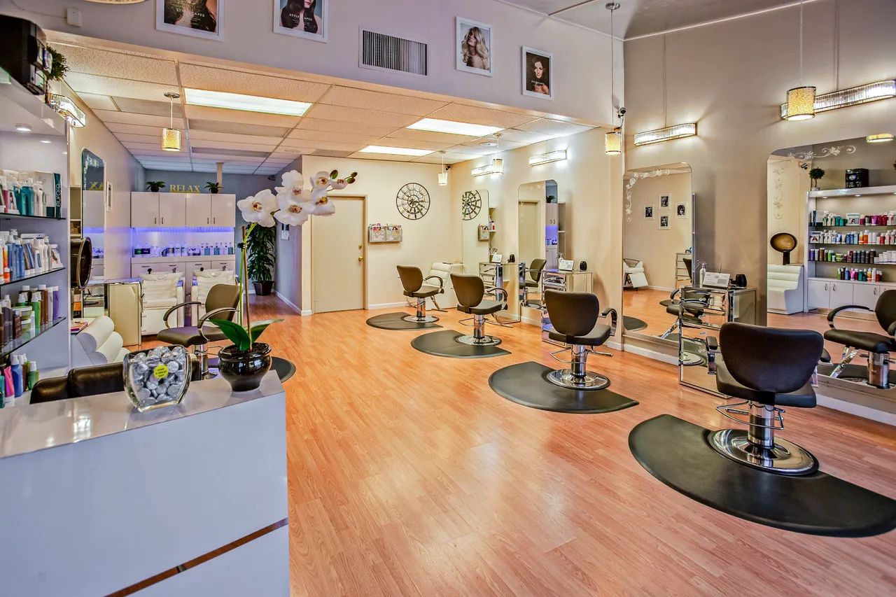 Spacious modern hair salon interior with styling chairs and mirrors