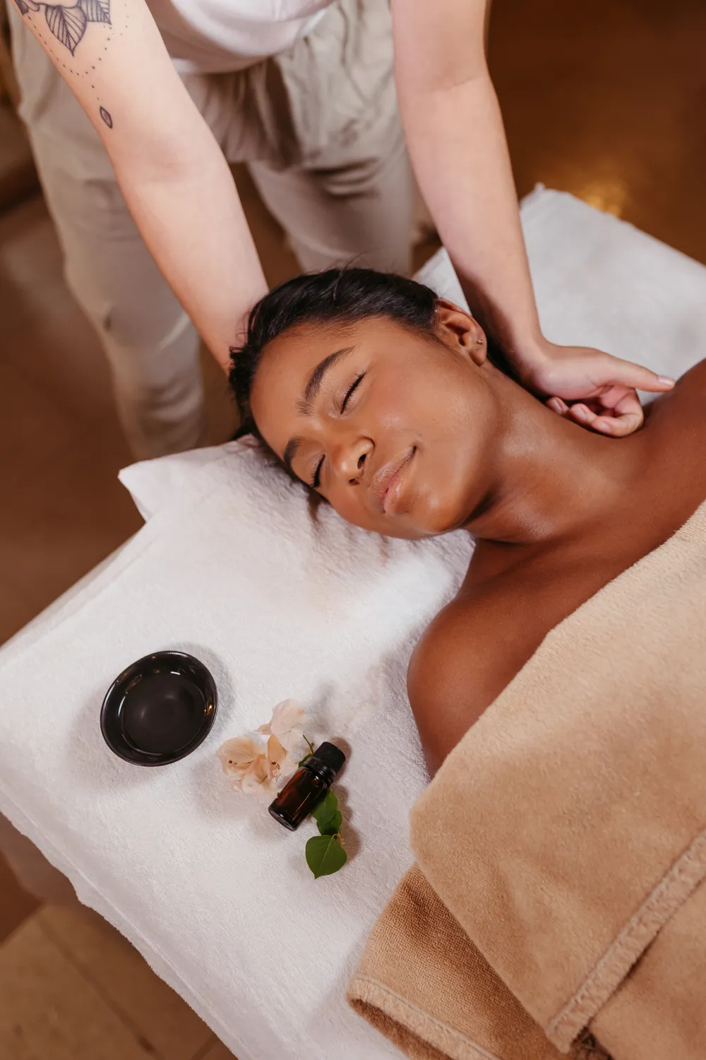 A woman receiving a soothing neck and aromatherapy massage at a professional day spa