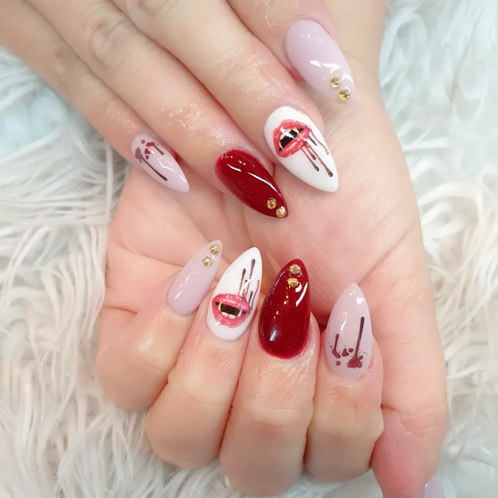 Close-up of almond-shaped nails with intricate red and white nail art after a manicure