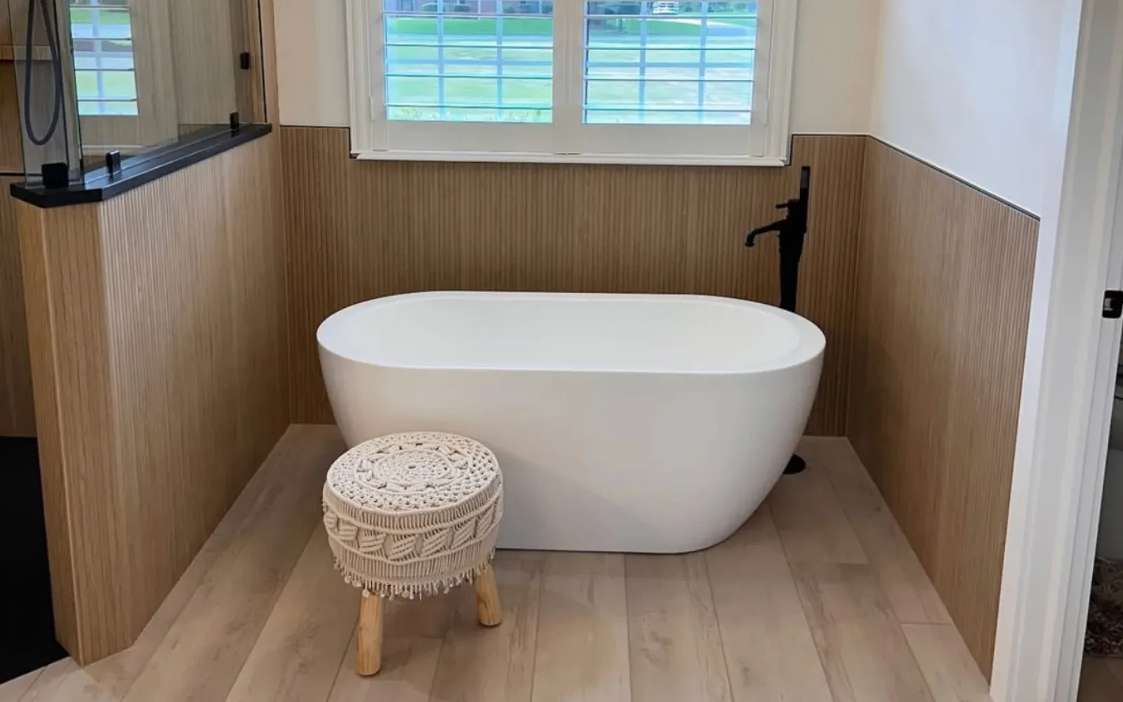 Freestanding tub in a finished bathroom with custom tile and stone work